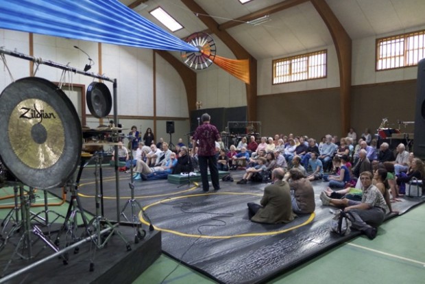 Audience members discuss pulsars with Tom Geballe before the performance in the Greenwood School gymansium